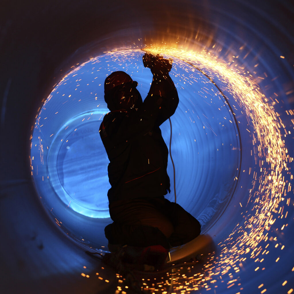 working welding inside a pipline with sparks flying